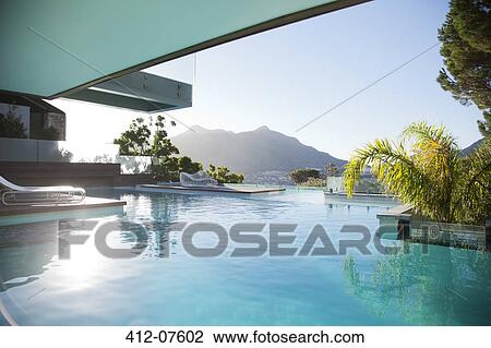 Luxury swimming pool with mountain view View Large Photo Image Stock Image - Luxury swimming pool with mountain view. Fotosearch