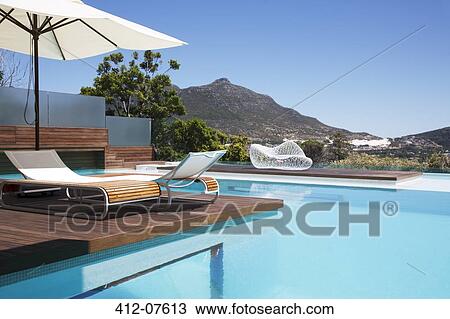Luxury swimming pool with mountain view View Large Photo Image Stock Image - Luxury swimming pool with mountain view. Fotosearch
