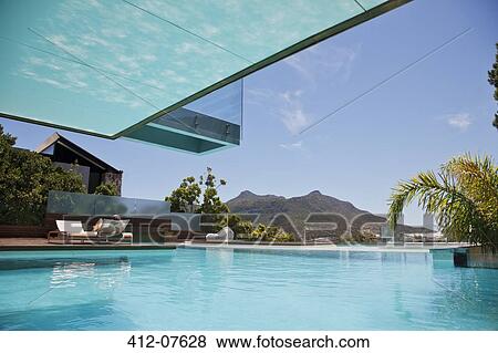 Luxury swimming pool with mountain view View Large Photo Image Stock Photo - Luxury swimming pool with mountain view. Fotosearch