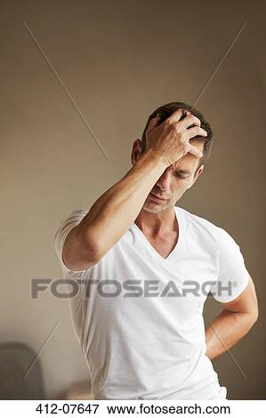 Man holding back and head in pain View Large Photo Image Stock Photo - Man holding back and head in pain. Fotosearch