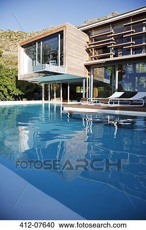 Modern house and swimming pool View Large Photo Image Stock Image - Modern house and swimming pool. Fotosearch