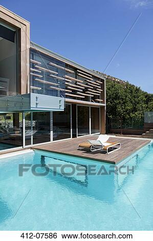 Modern house with patio and swimming pool View Large Photo Image Stock Photograph - Modern house with patio and swimming pool. Fotosearch