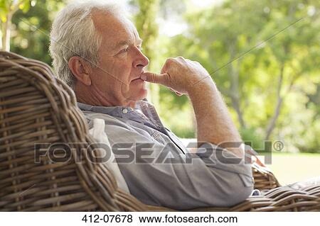 Pensive senior man sitting in wicker armchair on porch View Large Photo Image Stock Photo - Pensive senior man sitting in wicker armchair on porch. Fotosearch
