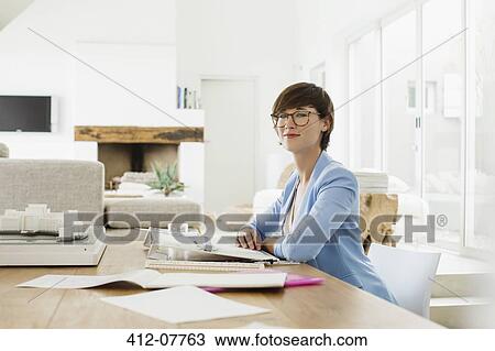 Stock Image - Portrait of confident architect at drawing board. Fotosearch