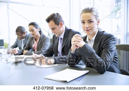 Portrait of confident businesswoman in meeting View Large Photo Image Stock Photo - Portrait of confident businesswoman in meeting. Fotosearch