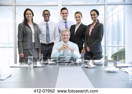 Portrait of smiling business people in conference room View Large Photo Image Stock Image - Portrait of smiling business people in conference room. Fotosearch