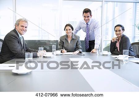 Portrait of smiling business people meeting in conference room View Large Photo Image Stock Photograph - Portrait of smiling business people meeting in conference room. Fotosearch