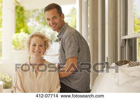 Portrait of smiling couple on porch View Large Photo Image Picture - Portrait of smiling couple on porch. Fotosearch