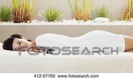 Portrait of smiling woman holding digital tablet and laying on patio sofa View Large Photo Image Stock Image - Portrait of smiling woman holding digital tablet and laying on patio sofa. Fotosearch
