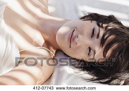 Portrait of smiling woman laying in bed View Large Photo Image Stock Image - Portrait of smiling woman laying in bed. Fotosearch