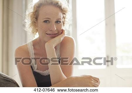 Portrait of smiling woman with head in hands View Large Photo Image Stock Photograph - Portrait of smiling woman with head in hands. Fotosearch