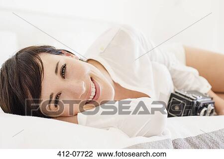 Portrait of smiling woman with vintage camera in bed View Large Photo Image Stock Image - Portrait of smiling woman with vintage camera in bed. Fotosearch
