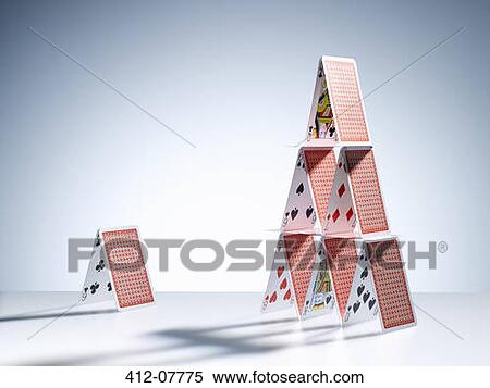 Small house of cards next to large house of cards View Large Photo Image Stock Photography - Small house of cards next to large house of cards. Fotosearch