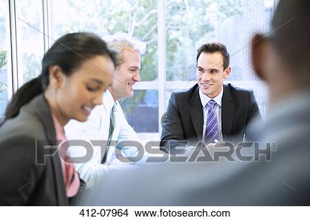 Smiling business people in meeting View Large Photo Image Picture - Smiling business people in meeting. Fotosearch
