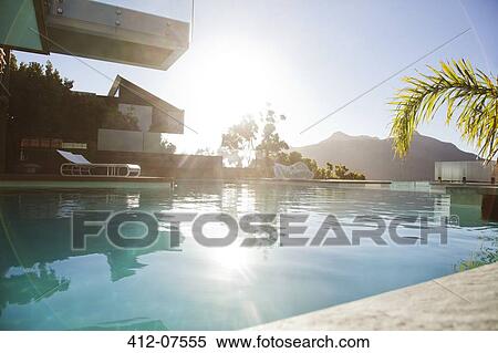 Sun over mountains and swimming pool View Large Photo Image Stock Photography - Sun over mountains and swimming pool. Fotosearch