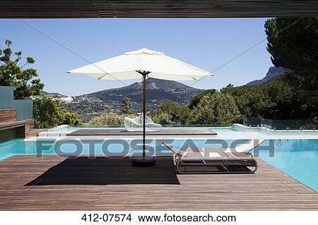 Swimming pool overlooking mountains View Large Photo Image Picture - Swimming pool overlooking mountains. Fotosearch