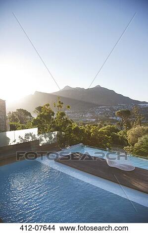 View of luxury swimming pool and mountains View Large Photo Image Picture - View of luxury swimming pool and mountains. Fotosearch