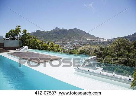 View of luxury swimming pool and mountains View Large Photo Image Stock Photo - View of luxury swimming pool and mountains. Fotosearch