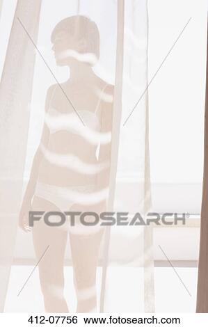 Woman in bra and underwear behind sunny curtain View Large Photo Image Stock Photograph - Woman in bra and underwear behind sunny curtain. Fotosearch