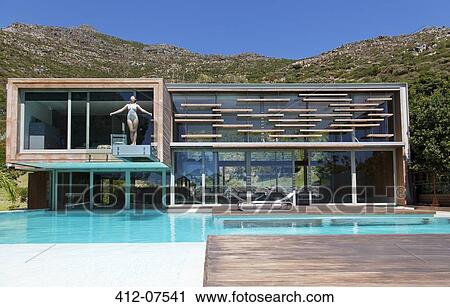 Woman on balcony over swimming pool View Large Photo Image Stock Image - Woman on balcony over swimming pool. Fotosearch