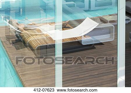 Woman sunbathing on lounge chair at luxury poolside View Large Photo Image Stock Image - Woman sunbathing on lounge chair at luxury poolside. Fotosearch