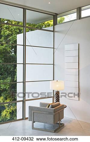 Stock Image - Armchair and lamp in modern living room. Fotosearch
