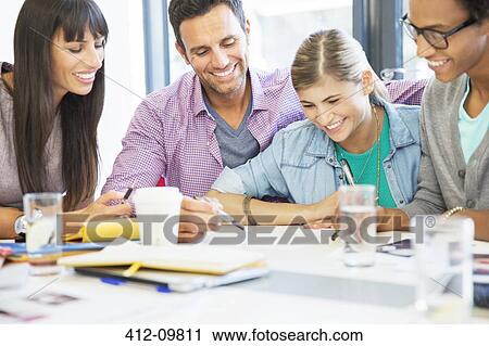 Stock Image - Business people talking in meeting. Fotosearch