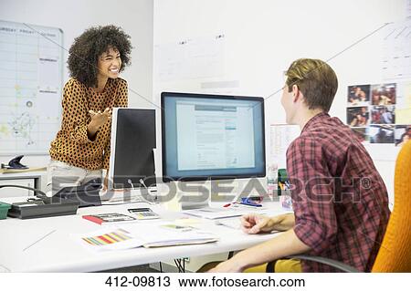 Stock Image - Business people talking in office. Fotosearch