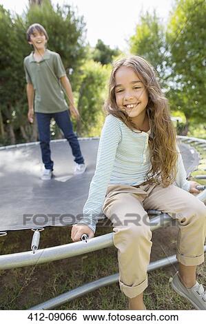Children smiling on trampoline View Large Photo Image Stock Photograph - Children smiling on trampoline. Fotosearch