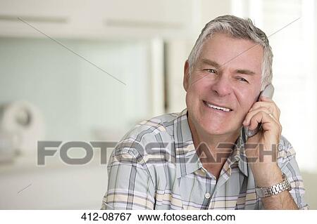 Stock Photo - Close up of senior man talking on telephone. Fotosearch