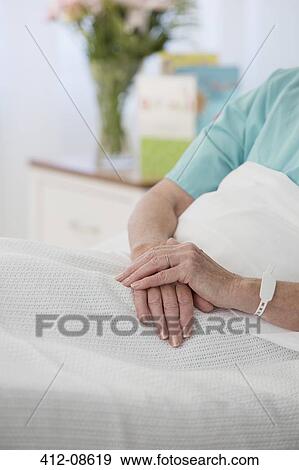 Close up of senior patient's hands in hospital bed View Large Photo Image Stock Photo - Close up of senior patient's hands in hospital bed. Fotosearch