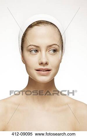 Stock Photography - Close up of woman with moisturizer on cheek. Fotosearch