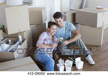 Couple enjoying champagne and Chinese take out food in new house View Large Photo Image Stock Image - Couple enjoying champagne and Chinese take out food in new house. Fotosearch
