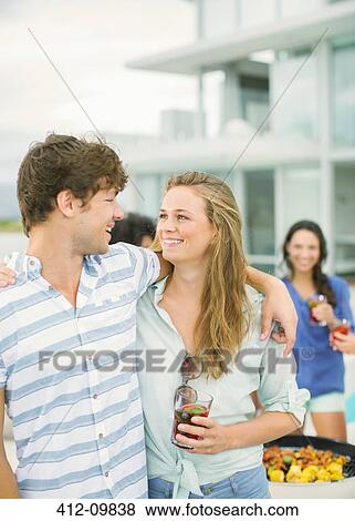 Couple hugging at barbecue View Large Photo Image Stock Photo - Couple hugging at barbecue. Fotosearch