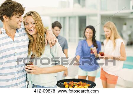 Couple hugging at barbecue View Large Photo Image Stock Photo - Couple hugging at barbecue. Fotosearch