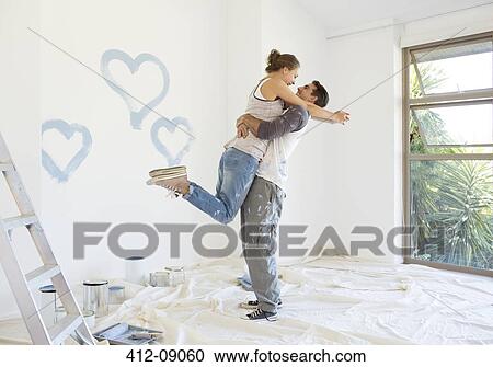 Couple painting blue hearts on wall View Large Photo Image Stock Image - Couple painting blue hearts on wall. Fotosearch