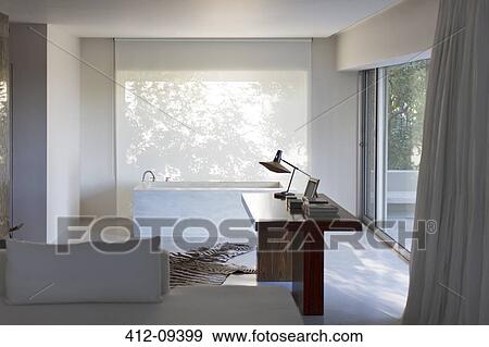 Desk and bathtub in modern house View Large Photo Image Stock Photo - Desk and bathtub in modern house. Fotosearch