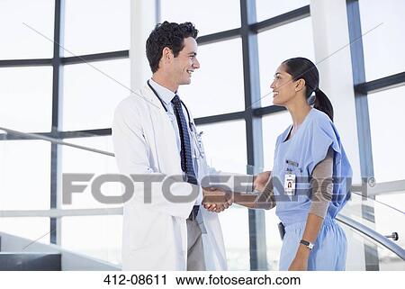 Doctor and nurse handshaking View Large Photo Image Stock Image - Doctor and nurse handshaking. Fotosearch