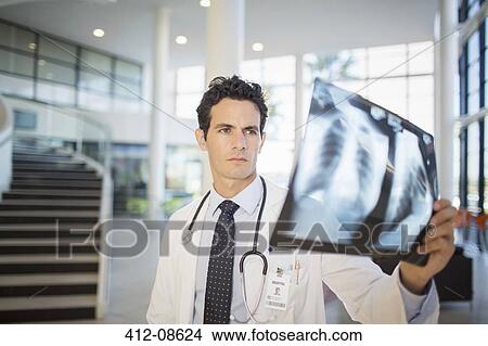 Doctor viewing chest x-rays in hospital View Large Photo Image Picture - Doctor viewing chest x-rays in hospital. Fotosearch