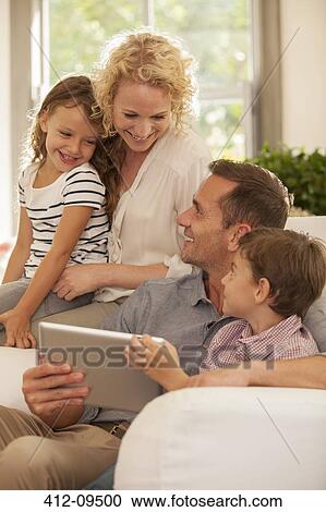 Family using digital tablet on sofa View Large Photo Image Stock Image - Family using digital tablet on sofa. Fotosearch