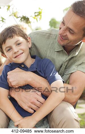 Father and son hugging outdoors View Large Photo Image Stock Photography - Father and son hugging outdoors. Fotosearch