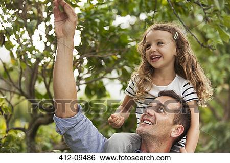 Father carrying daughter on shoulders View Large Photo Image Stock Photograph - Father carrying daughter on shoulders. Fotosearch