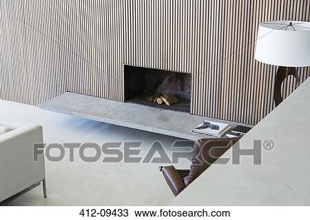 Stock Image - Fireplace and sofa in modern living room. Fotosearch
