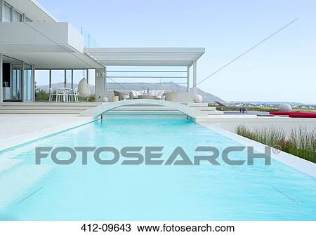 Stock Image - Footbridge over luxury swimming pool. Fotosearch