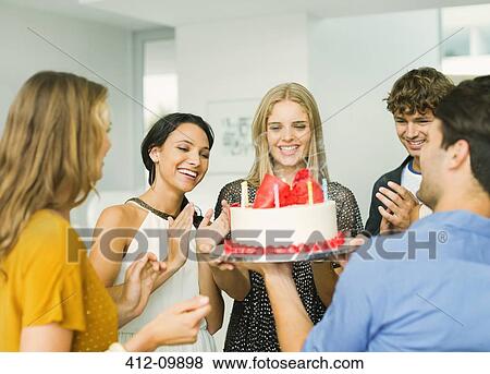 Friends clapping around woman with birthday cake View Large Photo Image Stock Photo - Friends clapping around woman with birthday cake. Fotosearch