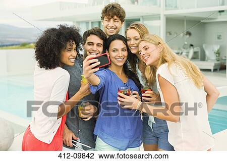 Friends taking picture together at party View Large Photo Image Stock Image - Friends taking picture together at party. Fotosearch
