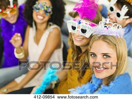 Friends wearing decorative glasses and crowns at party View Large Photo Image Picture - Friends wearing decorative glasses and crowns at party. Fotosearch