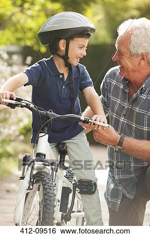 Grandfather teaching grandson to ride bicycle View Large Photo Image Stock Photograph - Grandfather teaching grandson to ride bicycle. Fotosearch