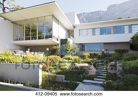 Landscaping in front yard of modern house View Large Photo Image Stock Photography - Landscaping in front yard of modern house. Fotosearch