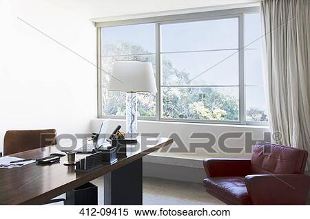 Laptop and lamp on desk in office View Large Photo Image Stock Photography - Laptop and lamp on desk in office. Fotosearch